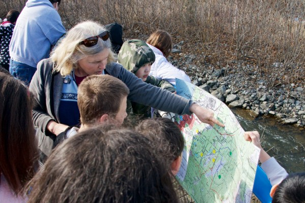 Photo by Deborah Mercy. Marilyn Sigman, Alaska Sea Grant marine educator, explains the Chester Creek watershed to an Anchorage student.